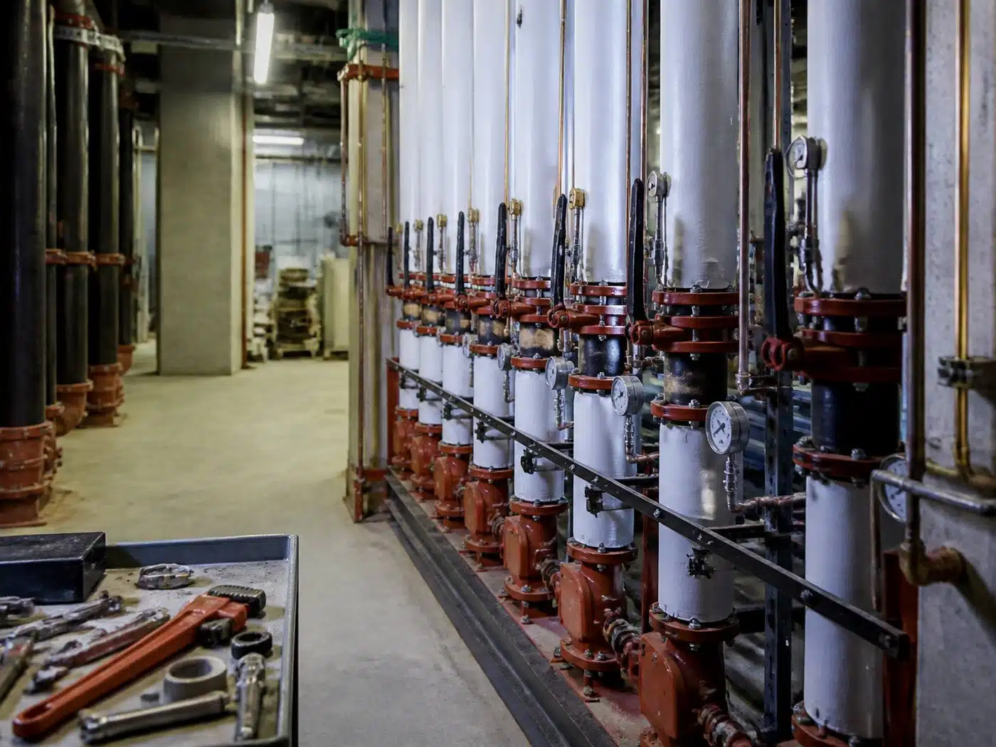 Wider view of the work area, commercial plumbing mechanical room with insulated risers and isolation valves in Denver