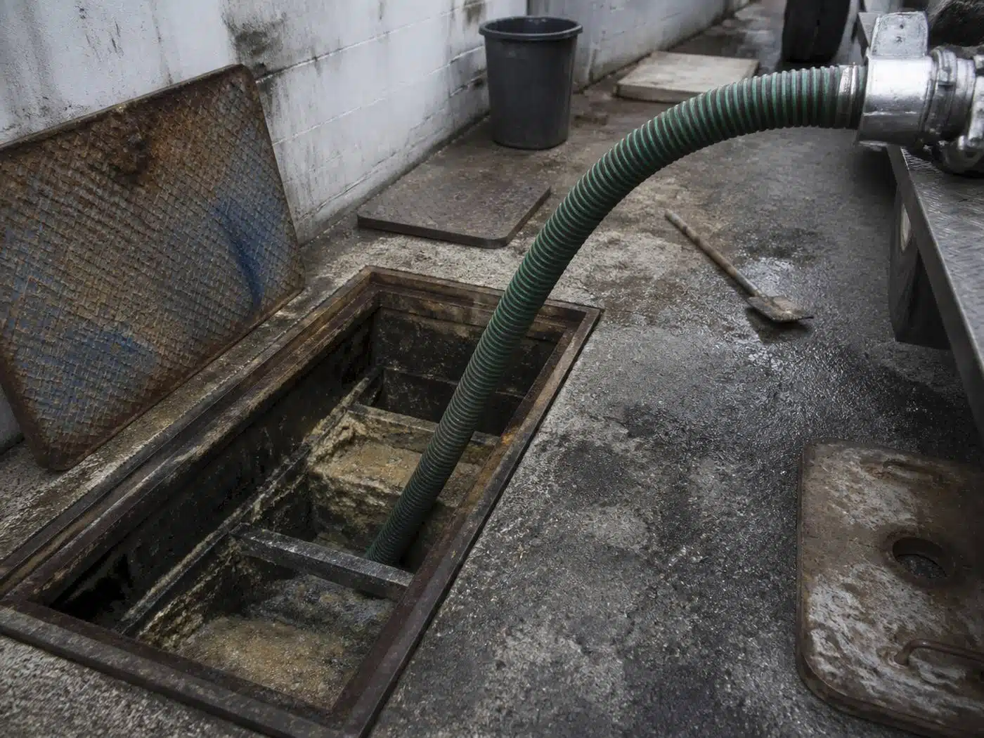 Wider view of the work area, exterior grease trap pump-out at the rear of a Denver restaurant