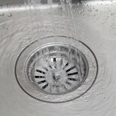 Water running freely down a cleared kitchen sink drain