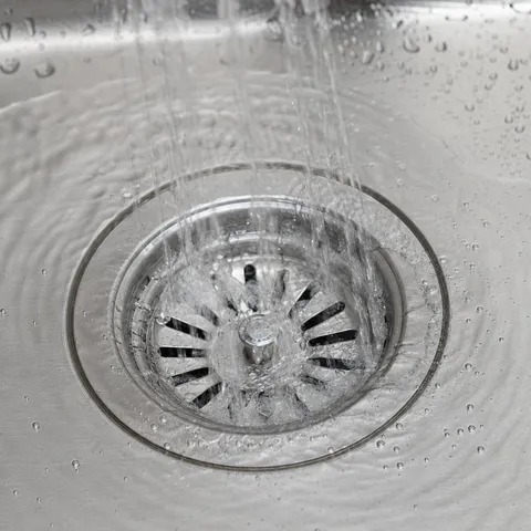 Water running freely down a cleared kitchen sink drain