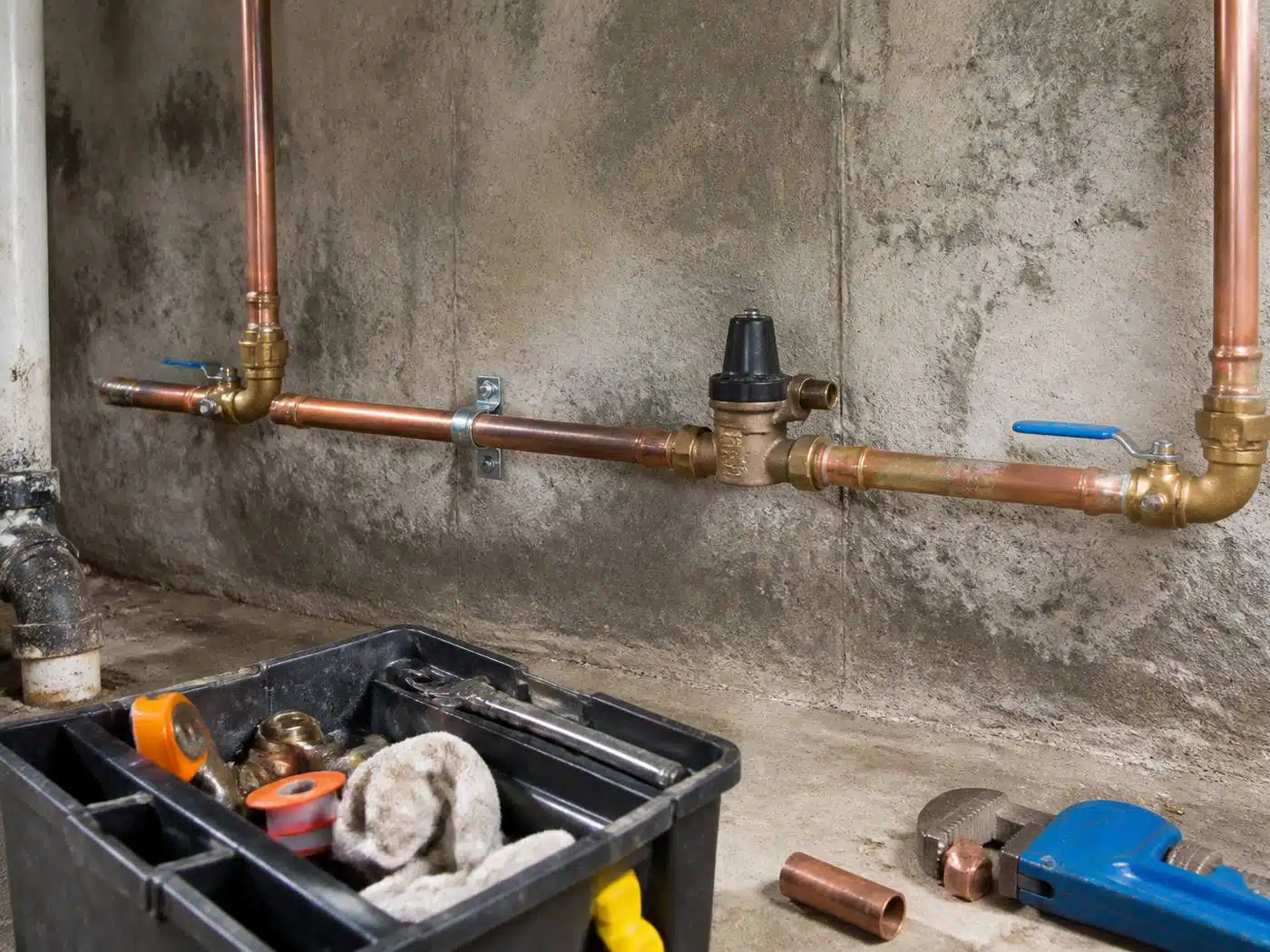 Wider view of the work area, new copper water service entry with shutoff and pressure reducing valve in a Denver basement
